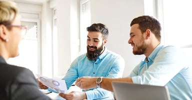 Business professionals discussing data around a conference table