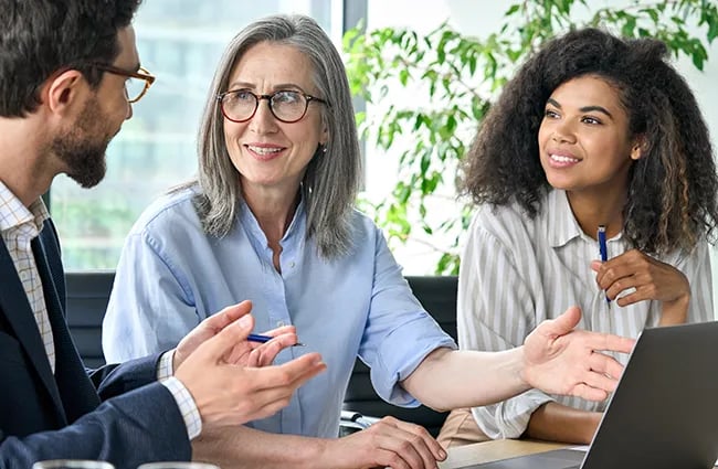 Business worker talking around laptop