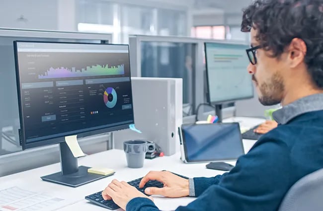 Data scientist reviewing data on a computer monitor
