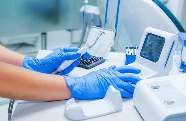 Gloved worker working with medical devices