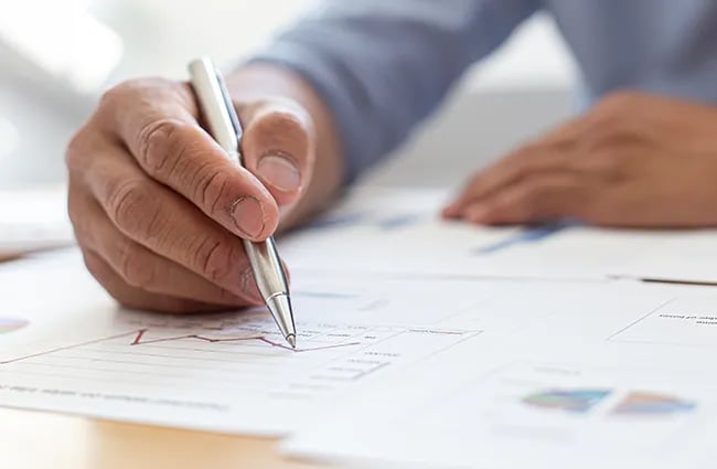 Hand writing on chart with a pen