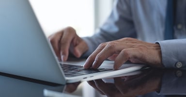 hands-of-regulatory-professional-typing-on-computer