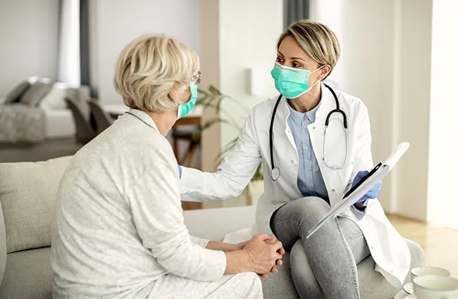 Health care worker with a patient in a home