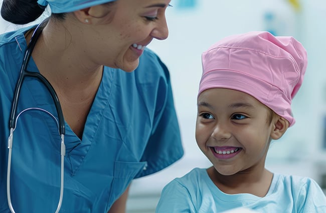 Healthcare worker and young girl patient smiling together