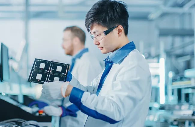 Person lab coat investigating a medical device