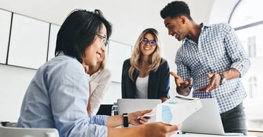Several business professionals having fun at a business meeting sharing data