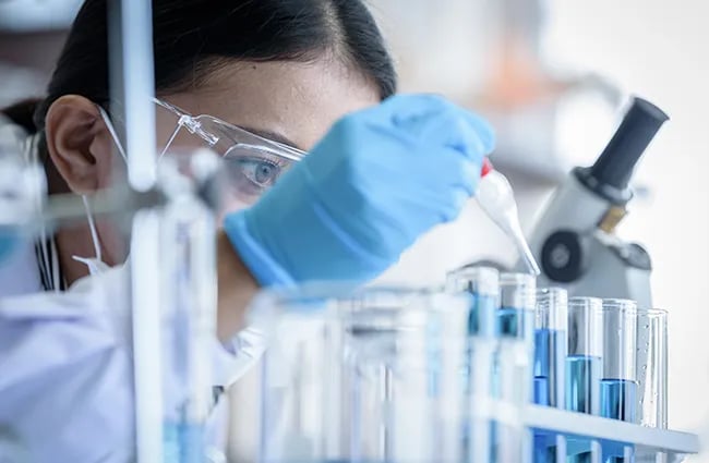 Woman focused on injecting test tube